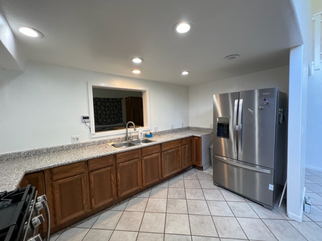 18-1976 Nau Nani Road Mountain View, HI 96771 - Photo 3 of 25 a kitchen with stainless steel appliances granite countertop a refrigerator and a sink