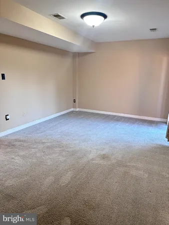 an empty room with wooden floor