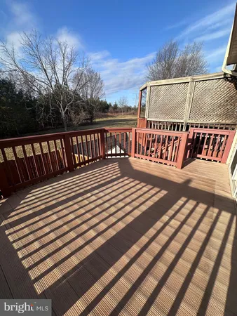 a view of balcony with wooden floor and fence