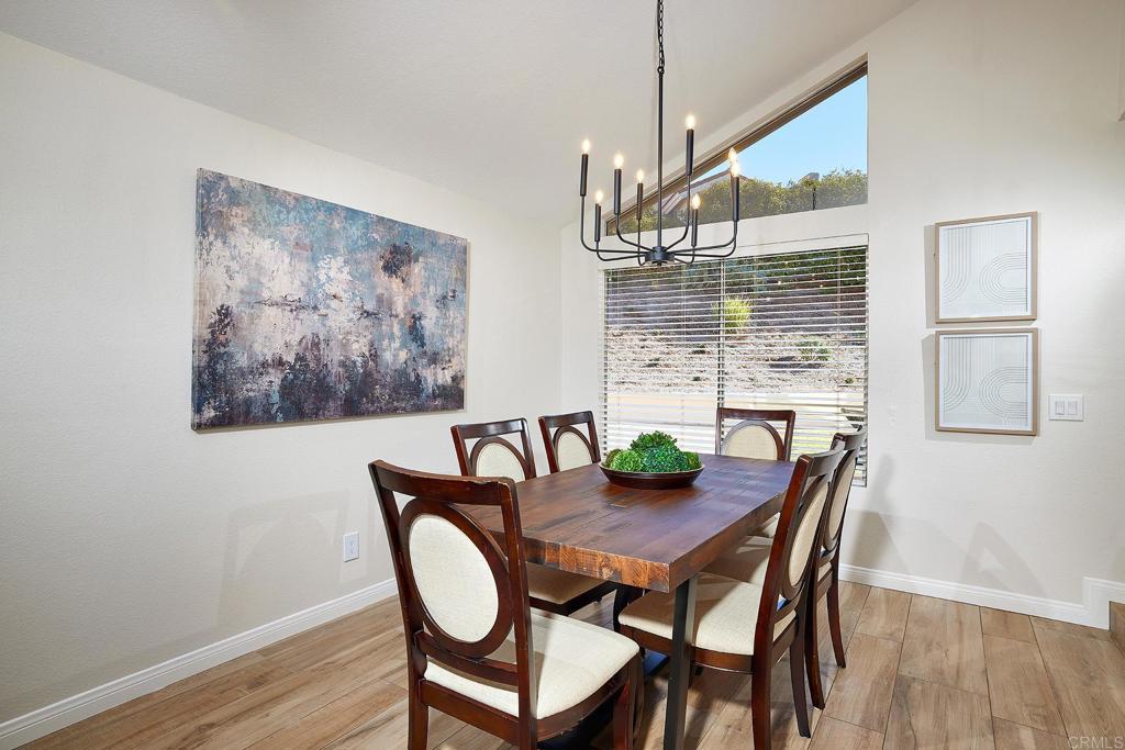 2107 Meadowgreen Court Encinitas, CA 92024 - Photo 11 of 49 a view of a dining room with furniture window and wooden floor