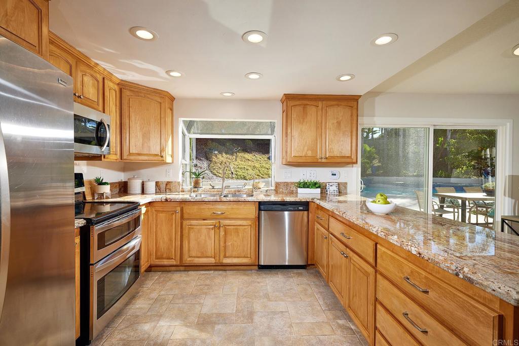 2107 Meadowgreen Court Encinitas, CA 92024 - Photo 14 of 49 a kitchen with stainless steel appliances granite countertop a sink and stove