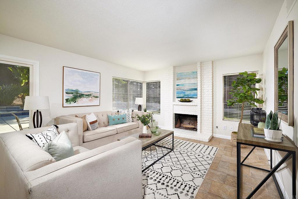 2107 Meadowgreen Court Encinitas, CA 92024 - Photo 15 of 49 a living room with furniture a fireplace a flat screen tv and a fireplace