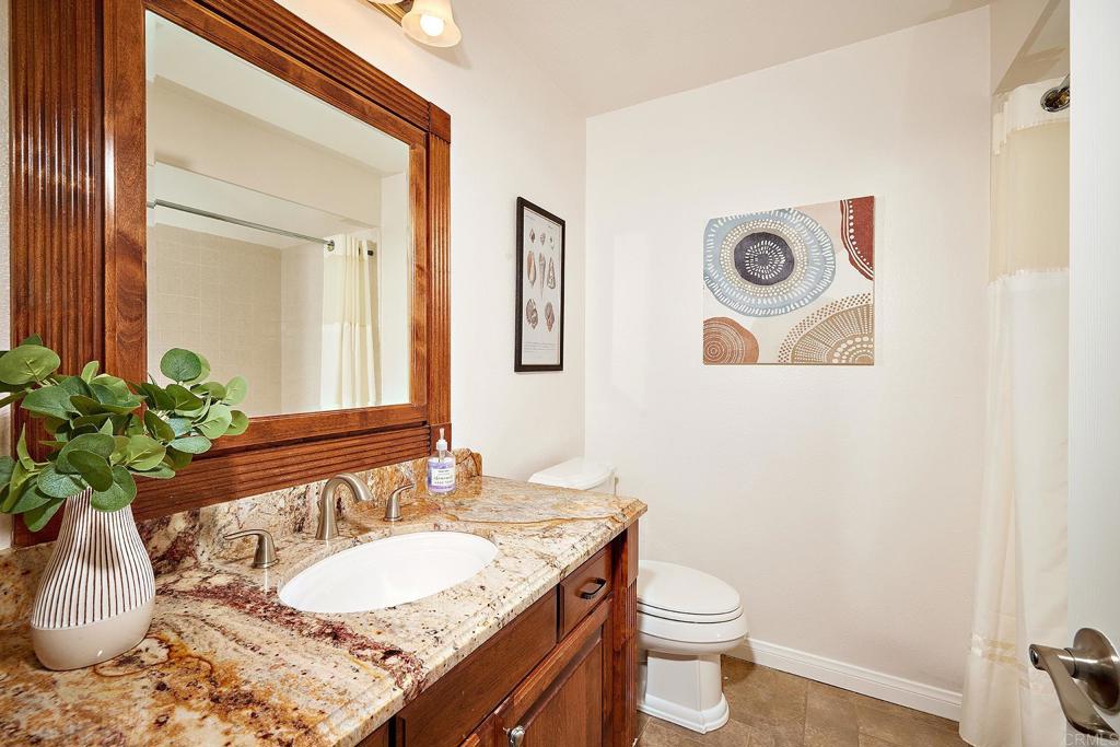 2107 Meadowgreen Court Encinitas, CA 92024 - Photo 18 of 49 a bathroom with a granite countertop sink and a mirror