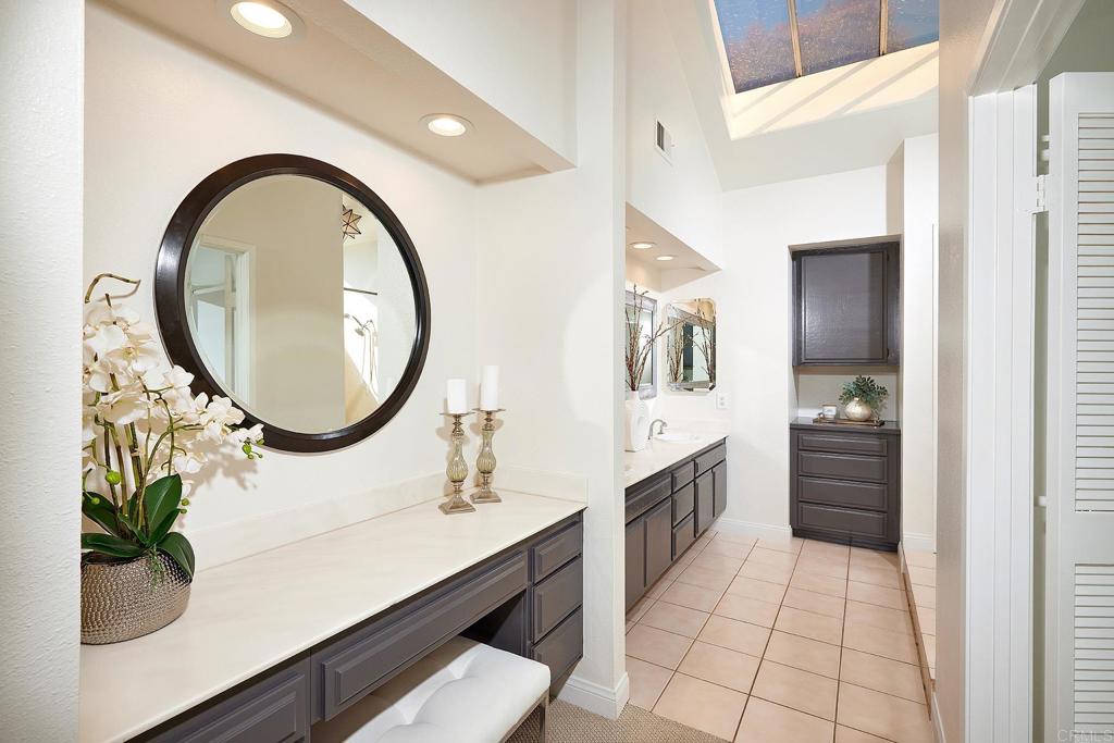 2107 Meadowgreen Court Encinitas, CA 92024 - Photo 21 of 49 a bathroom with a sink a vanity and a mirror