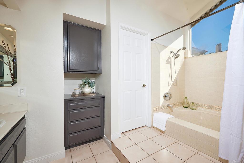 2107 Meadowgreen Court Encinitas, CA 92024 - Photo 23 of 49 a bathroom with a bathtub vanity and a shower