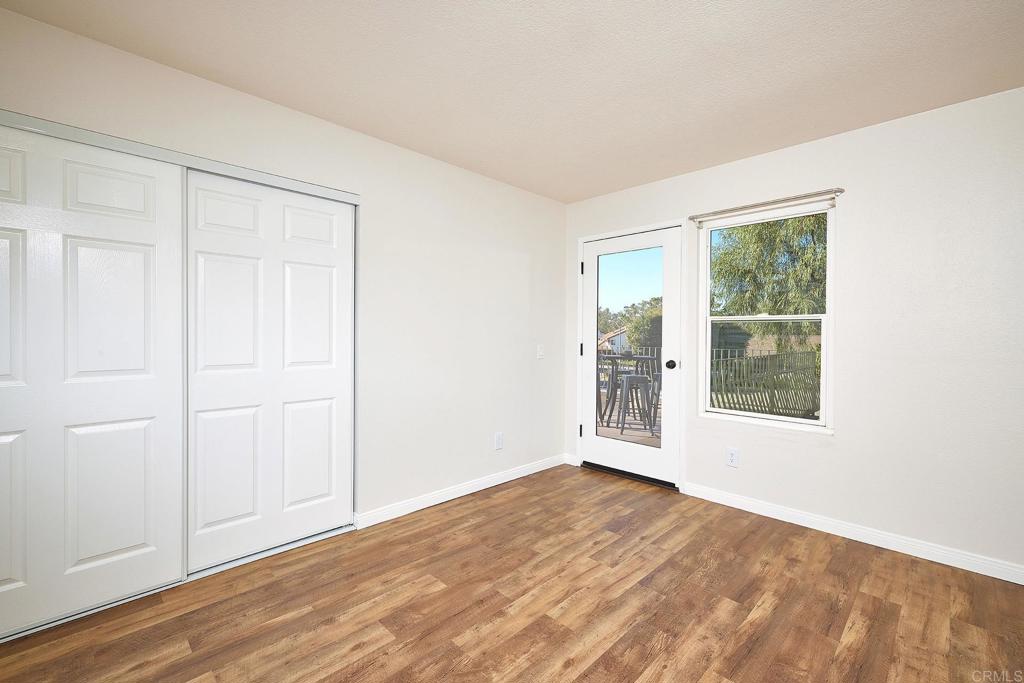 2107 Meadowgreen Court Encinitas, CA 92024 - Photo 25 of 49 an empty room with wooden floor and windows