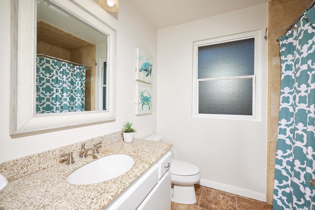 2107 Meadowgreen Court Encinitas, CA 92024 - Photo 26 of 49 a bathroom with a granite countertop sink and a mirror