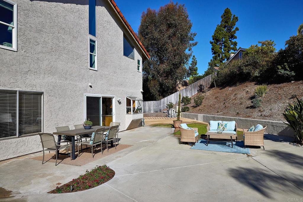 2107 Meadowgreen Court Encinitas, CA 92024 - Photo 30 of 49 a view of a patio with table and chairs and potted plants