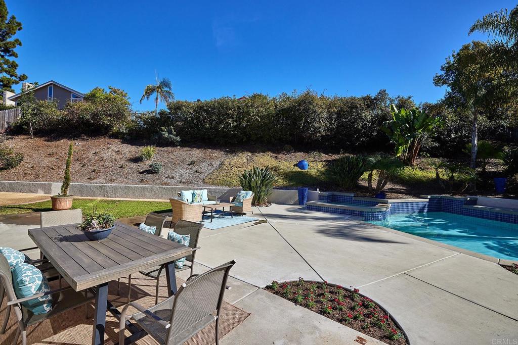 2107 Meadowgreen Court Encinitas, CA 92024 - Photo 32 of 49 a view of swimming pool with outdoor seating and trees in the background