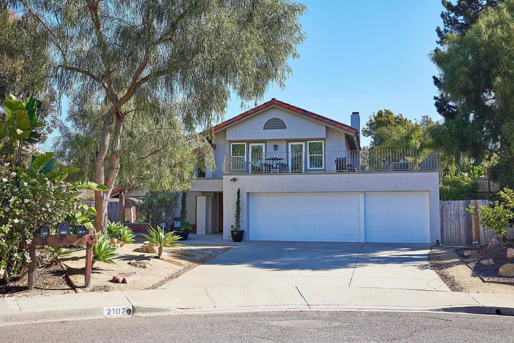 2107 Meadowgreen Court Encinitas, CA 92024 - Photo 6 of 49 a front view of a house with a garden and garage