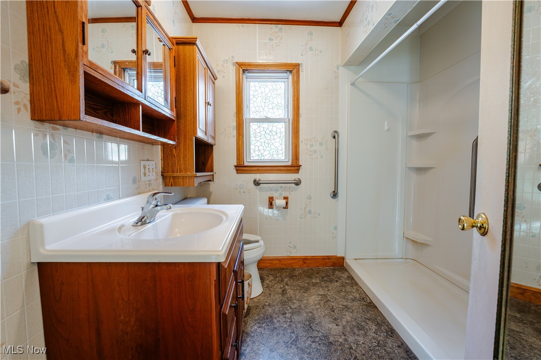 4829 Frys Valley Road Southwest Port Washington, OH 43837 - Photo 16 of 46 Full bath featuring vanity, a shower stall, tile walls, and crown molding