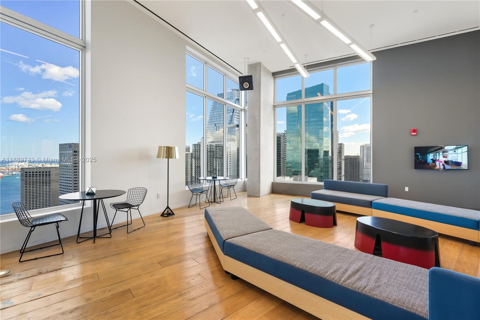 151 Southeast 1st Street, Unit 2002 Miami, FL 33131 - Photo 12 of 16 a living room with furniture wooden floor and a large window