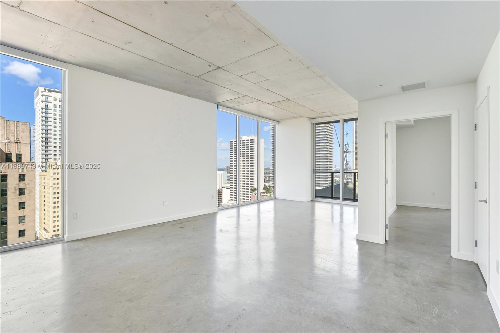 151 Southeast 1st Street, Unit 2002 Miami, FL 33131 - Photo 2 of 16 a view of an empty room with wooden floor and a window