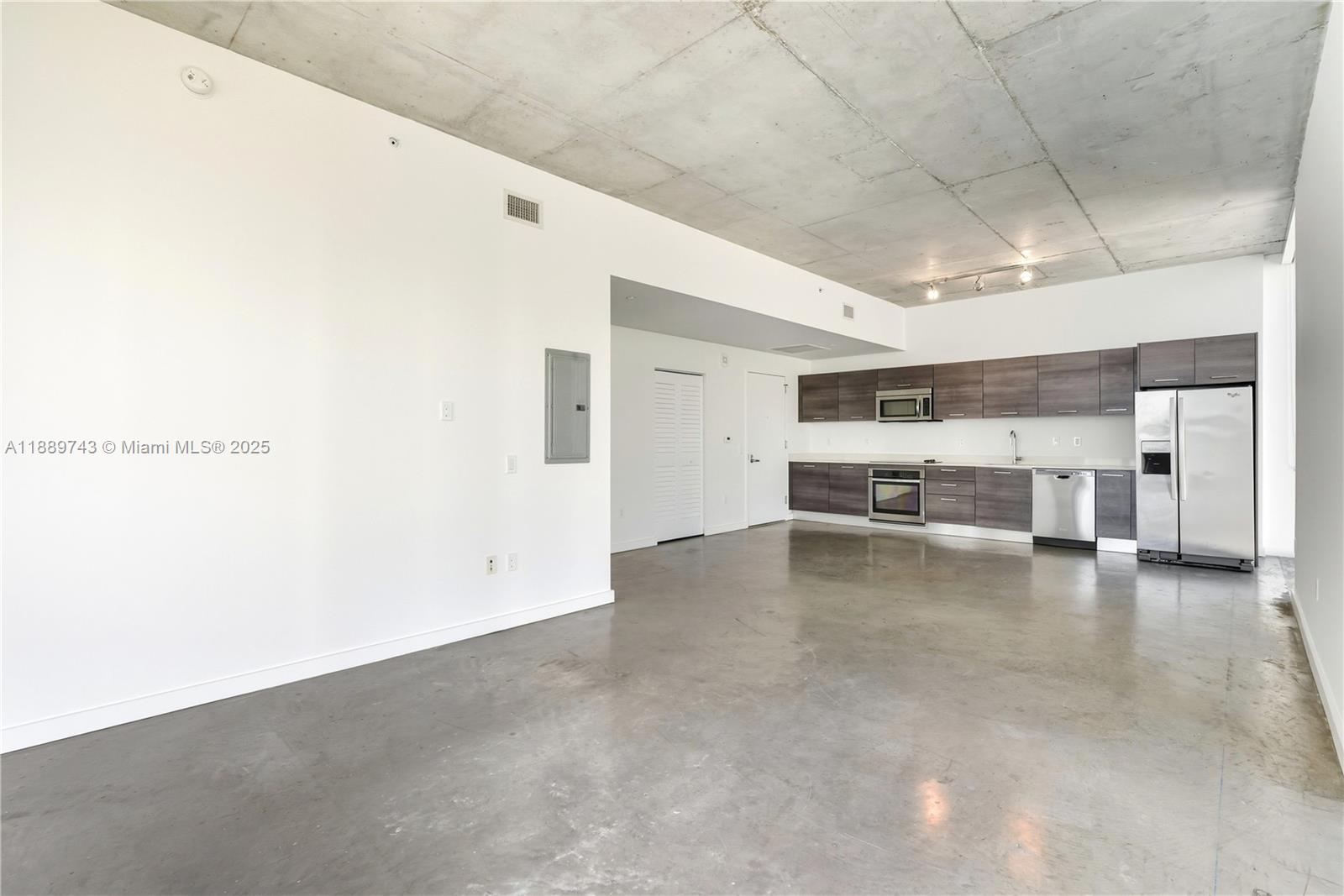 151 Southeast 1st Street, Unit 2002 Miami, FL 33131 - Photo 3 of 16 a view of a livingroom with furniture and kitchen view