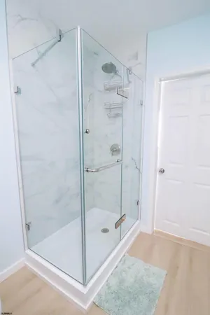 a bathroom with a glass shower door
