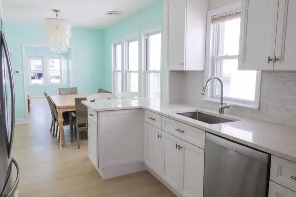 a kitchen that has a lot of cabinets in it and appliances