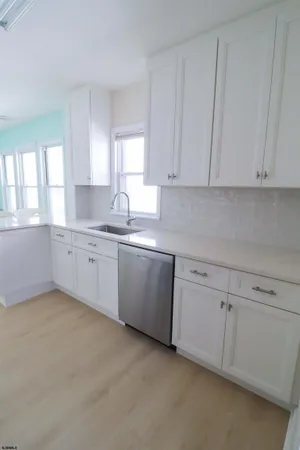 a kitchen with white cabinets