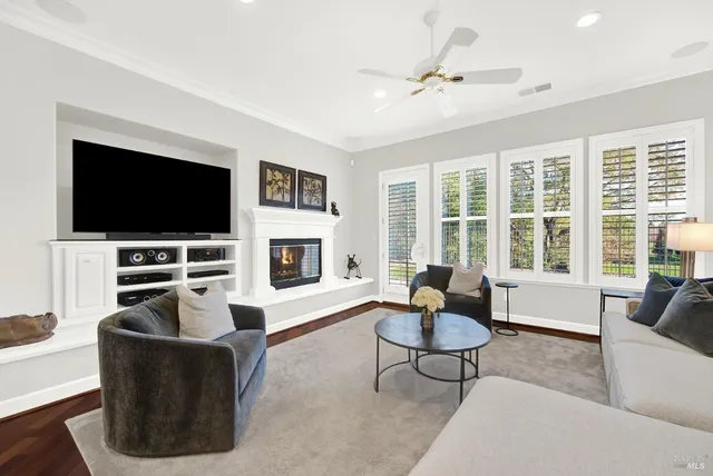 a dining room with furniture wooden floor and a chandelier