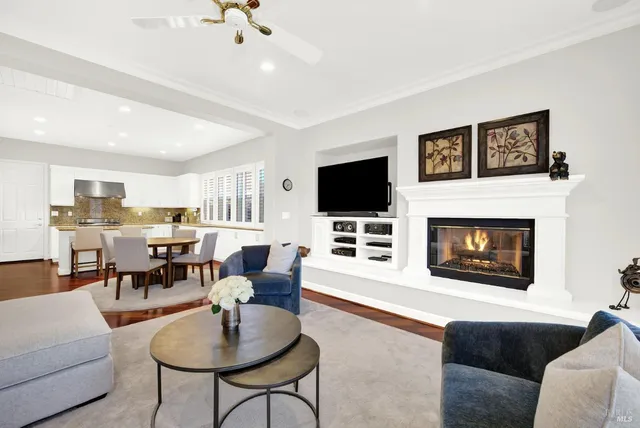 a kitchen with granite countertop white cabinets and stainless steel appliances