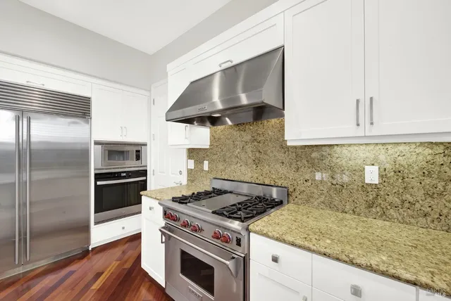 a spacious bedroom with a bed and a couch