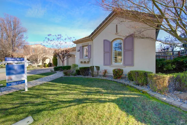a view of a hallway with wooden floor and a living room