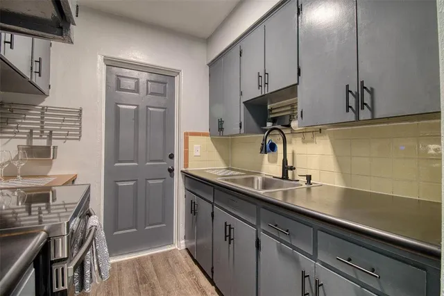 a kitchen with a sink appliances and cabinets