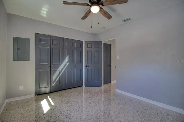 a view of an empty room with a ceiling fan