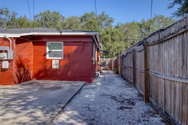 a view of a backyard with wooden fence