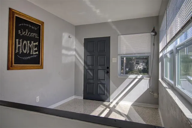 a view of a hallway with wooden floor and a fireplace