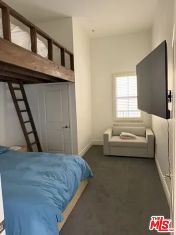 a bedroom with furniture and a flat screen tv