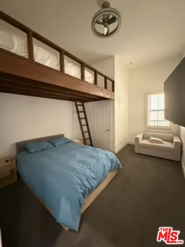 a bed room with a bed and a large window