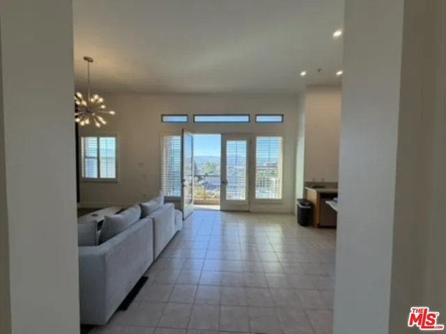 a lobby with furniture and floor to ceiling window