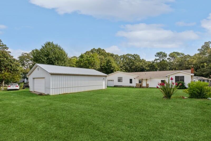 5867 Oak Hill Road Crestview, FL 32536 - Photo 1 of 33 a view of a house with a yard and fence