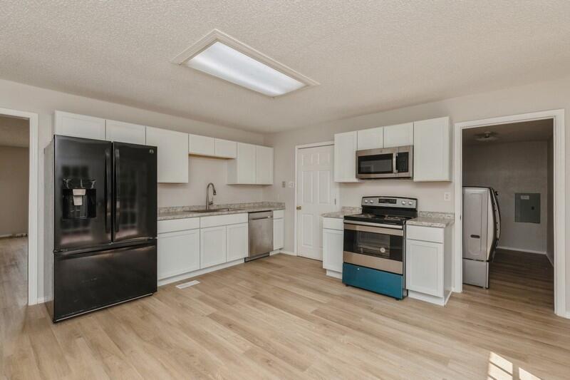5867 Oak Hill Road Crestview, FL 32536 - Photo 13 of 33 a kitchen with a refrigerator stove and sink