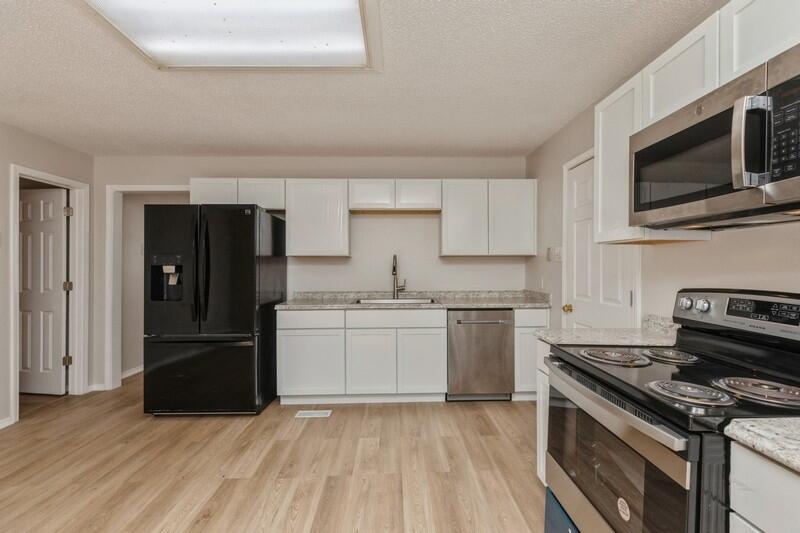 5867 Oak Hill Road Crestview, FL 32536 - Photo 14 of 33 a kitchen with a stove and a microwave