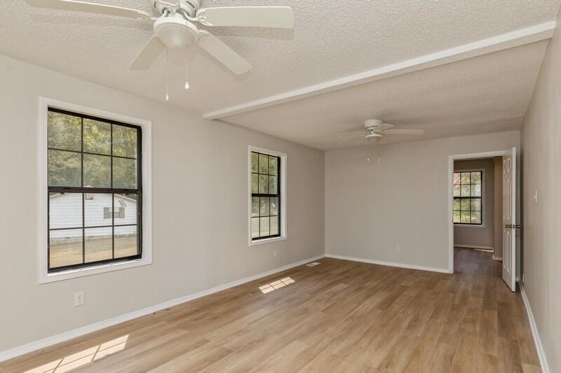 5867 Oak Hill Road Crestview, FL 32536 - Photo 24 of 33 wooden floor in an empty room with a window