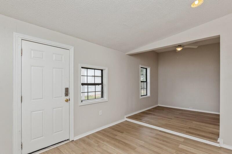 5867 Oak Hill Road Crestview, FL 32536 - Photo 8 of 33 an empty room with wooden floor and windows