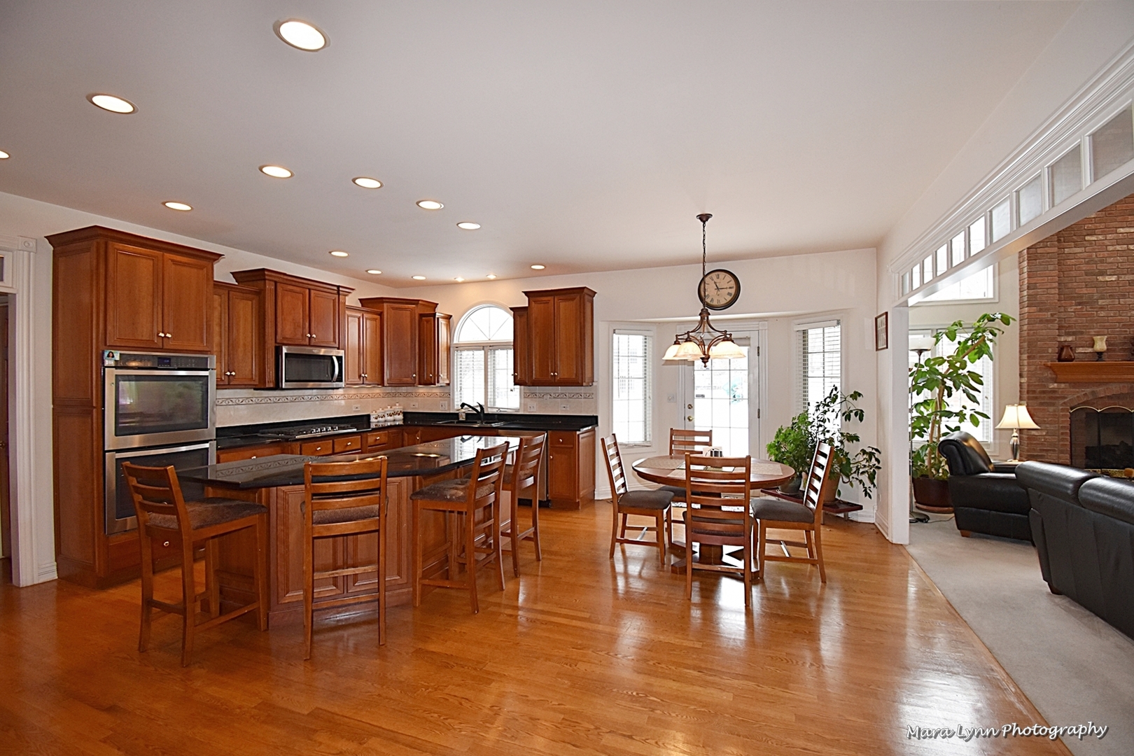 3N853 Walt Whitman Road Campton Hills, IL 60175 - Photo 11 of 48 a kitchen with stainless steel appliances granite countertop a stove top oven a sink dishwasher a dining table and chairs with wooden floor