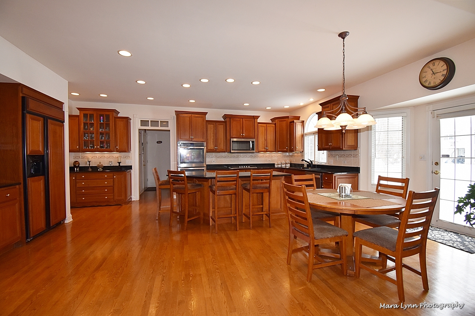 3N853 Walt Whitman Road Campton Hills, IL 60175 - Photo 14 of 48 a view of a dining room and livingroom with furniture wooden floor a chandelier