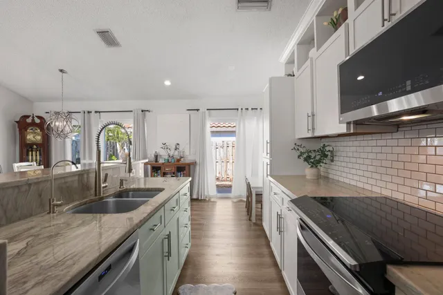 a bathroom with a granite countertop sink mirror and a bath tub