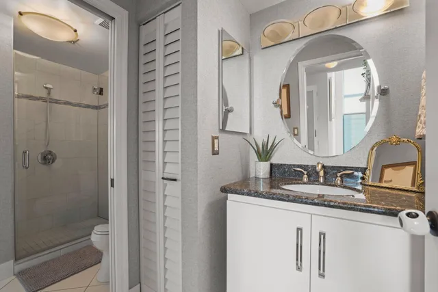 a backyard of a house with table and chairs plants and a barbeque