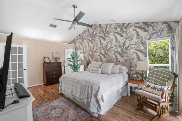 an aerial view of house with yard and trees in the background