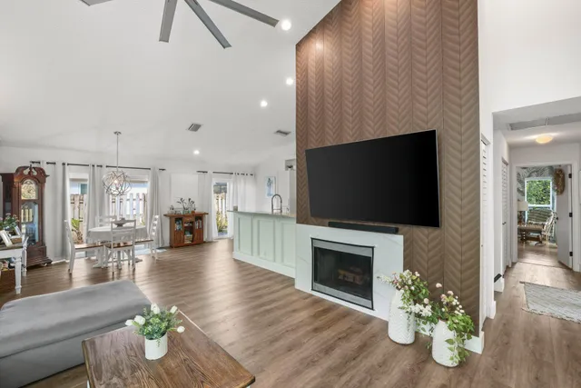 a living room with furniture a fireplace and a flat screen tv