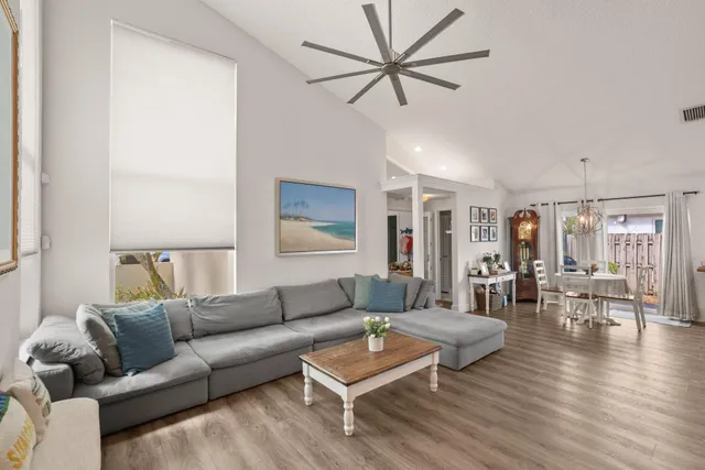 a living room with furniture a flat screen tv and a window