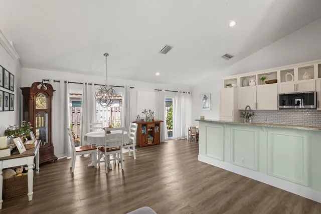 a kitchen with stainless steel appliances granite countertop a refrigerator stove and sink