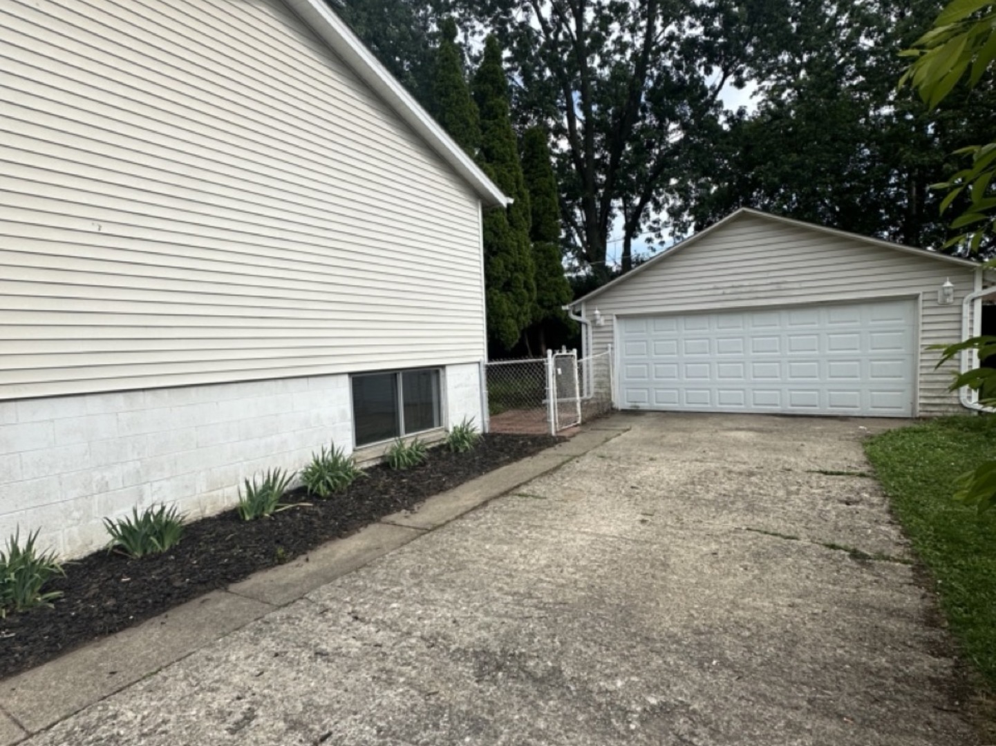 221 Murphy Drive Romeoville, IL 60446 - Photo 11 of 13 a small white house with a yard and garage