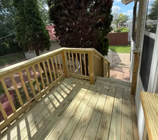 a view of balcony with wooden floor