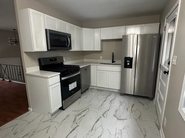 a kitchen with a sink stove and refrigerator