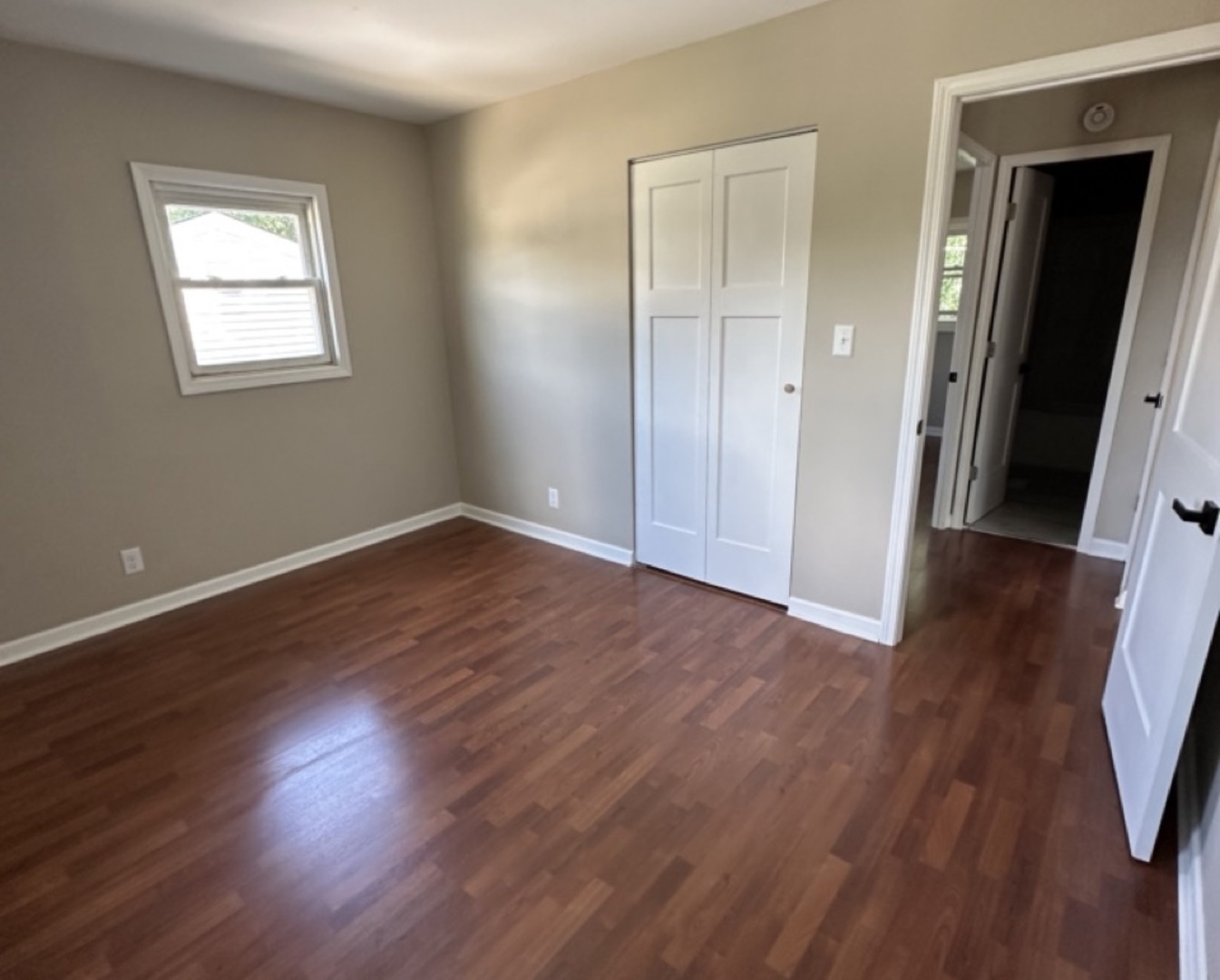221 Murphy Drive Romeoville, IL 60446 - Photo 5 of 13 an empty room with wooden floor and windows
