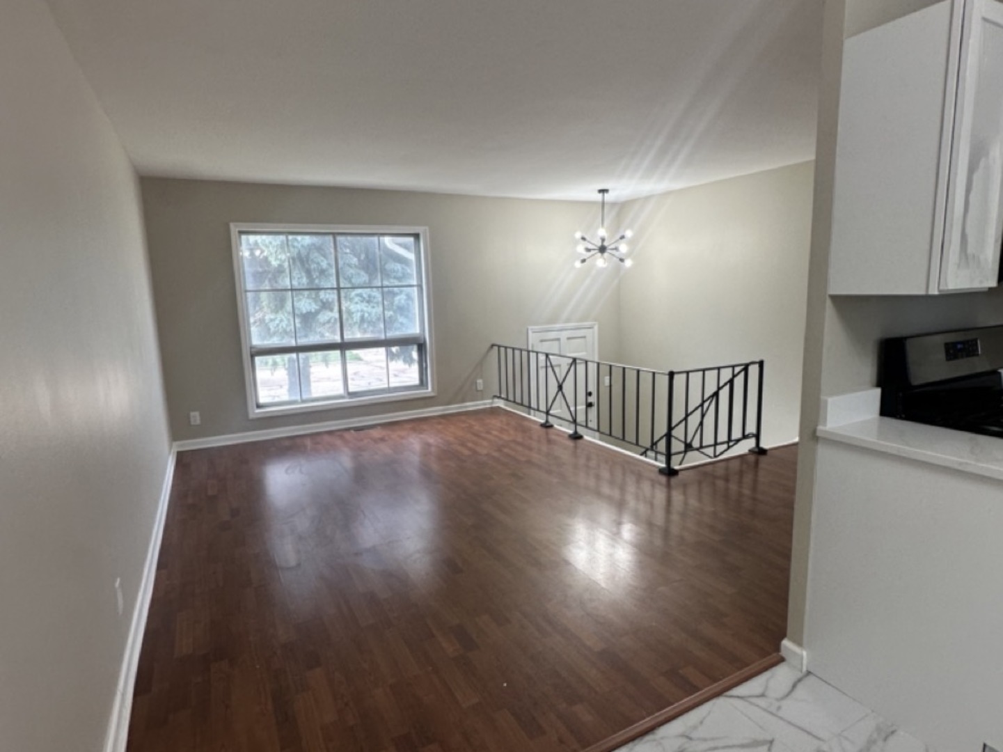 221 Murphy Drive Romeoville, IL 60446 - Photo 6 of 13 a view of an empty room with wooden floor and a window